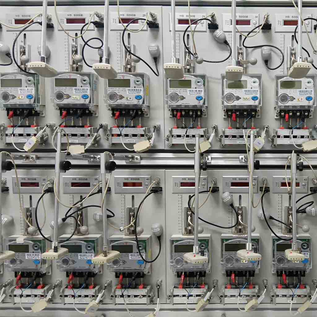 Technicians performing meter verification in an ISO/IEC 17025 accredited laboratory